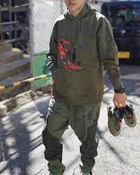 Dressed in a medium olive, black, sail and university red colourway; Jordan 6 Retro Travis Scott Travis Scott Outfits Mens Outfits Travis Scott
