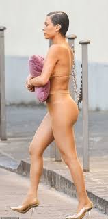 EXCLUSIVE: Kanye Wests wife Bianca Censori steps out in Italy TOPLESS in  a ripped garment while using purple CUSHION to cover her breasts in most  indecent display yet - hours after dining