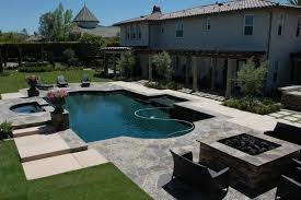 Having a waterfall in the pool produces a tranquil sound that can help you relax. Stunning Backyard With Pool Hot Tub Covered Patio And Fire Pit Stunning Outdoor Kitchen With Color Changing Lights Pool Landscape Design Pool Backyard Pool