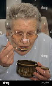 Poor poverty senior eating hi-res stock photography and images