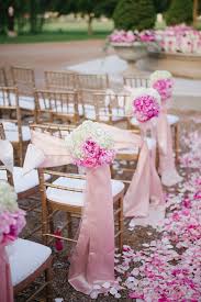 Ceremony flower decorations are necessary to a beautiful garden wedding. Pink Flower Chair And Aisle Decorations