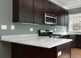 Dark Cabinets With White Granite Countertops White Countertops White Granite Countertops Dark Brown Kitchen Cabinets