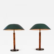 Description a classic piece that illuminates the head curator's office in a major contemporary art museum inspired this modern table lamp. Paavo Tynell Pair Of 1940s Bohlmarks Brass And Leather Table Lamps