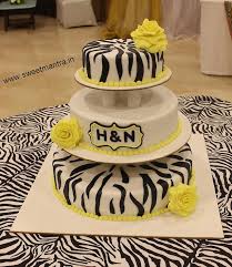 Carefully position the plated tier on the pillars. 3 Tier Designer Fondant Cake With Pillars For Wedding Cakesdecor