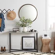 A Scandinavian Style Entryway With A Circular Wall Mirror Black Minimalist Iron Con Cheap Living Room Furniture Home Decor Online Living Room Furniture Online