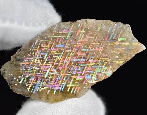 At first glance, this looks like a piece of futuristic technology trapped  inside crystal—but it's actually a real gemstone called Rainbow Lattice  Sunstone. Found only in a small, remote area of Australia's