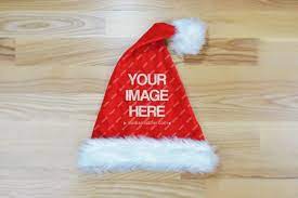 Dreaming Of A White Christmas Don T Just Dream About It Make It Happen A Mockup Template Featuring A Red Santa Hat Lying On Santa Hat Custom Branding Mockup