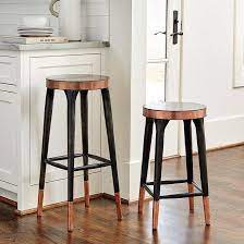 From real and faux leather seats, to wooden and plastic; Melandri Copper Banded Black Stools