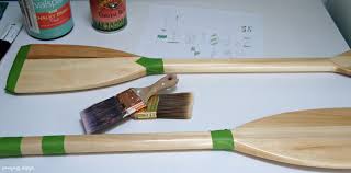 A single oar hung in a hallway and studded. Instant Nautical Decor Learn How To Make Painted Oars For Decoration