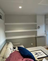 Another before-and-after that shows how much wallpaper and styling can warm  up a space. This little room is actually in our basement and it functions  as both our media room and my