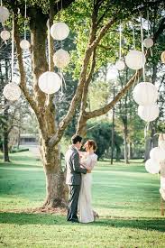 12 Ways To Decorate Trees At Your Spring Wedding Wedding Ceremony Backdrop Wedding Tree Wedding
