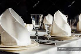 Set of items of cutlery and glassware laid at a dining table. Closeup View Of Formal Table Setting Restaurant Cutlery Stock Photo 237839152