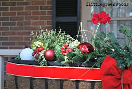 This planter box with brass handles is filled. Cheery Christmas Flower Boxes For Outdoor Christmas Decorating