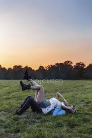 Последние твиты от cloud meadow (@cloud_meadow). Happy Couple In Love Lying On A Meadow At Sunset Enjoyment People Stock Photo 178186544