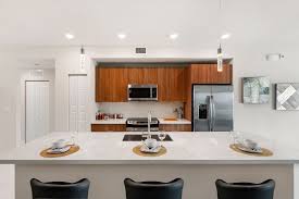 Open Kitchen Design At The Emory In Park Central S Apex Brown Cabinets Quartz Countertop Ki Kitchen Design Open Quartz Kitchen Countertops Brown Cabinets