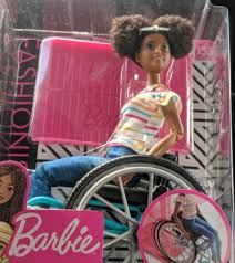 Barbie released a new black doll with a hairstyle featuring cornrows and a blonde weave. New Black Barbie Doll Wears Natural Hair Uses A Wheelchair