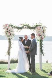 A wedding arch is basically just a picture frame for your love. Blush And Ivory Flower Decorated Wooden Wedding Arch