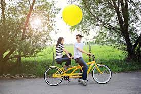 Umbrellas and chairs, kayaks and bikes. A Yellow Tandem Bicycle Engagement Shoot Tandem Bicycle Tandem Bike Park City Weddings