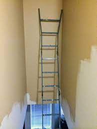 Place the one leg of the ladder on one step and the other leg, with the ladder leveler. How To Paint A Tall Hallway Above Stairs Above Stairs Decor Stair Decor Stair Wall Decor