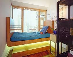Beautiful bed with a full sets of sheets and cushion on a dark grain wood board. 15 Stylish Asian Bedroom Ideas
