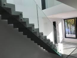 Acrylic cantilevered treads with glazed guards and railings keep the visual appearance of the stair light and airy allowing the living and dining spaces to flow together. Glass Balustrades Glass Banisters Stairs Stevenage Glass