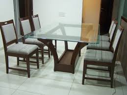 Featuring a contemporary design with a minimalist glass table top and a natural base with tapered wood legs and black supports, this modern table is a stylish update to any dining space. Most Beautiful And Mesmerizing Dining Table Design Ideas