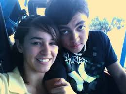 This is my husband and me in our very first ever picture together. Can  anyone fix it and make it frameable? Please ❤️