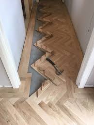 Gluing In The Pieces Oak Herringbone Parquet Wood Floor Design Herringbone Wood Floor Oak Parquet Flooring