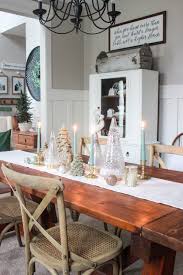 Styled with a custom gallery wall with black and white art, acrylic console, and dwr mantis wall sconce. Sage Green And Blue Christmas Dining Room Delightfully Noted