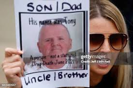 Liz Daly, Layla Miller and Joanne Daly hold a picture of Tony Devine...  News Photo
