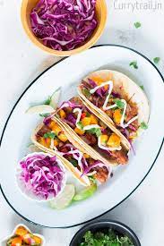 The seasoned tilapia fillets are baked in the oven until flaky, then filled into soft tortillas with your favorite toppings. Easy Tilapia Fish Tacos Recipe With Mango Salsa Video Currytrail