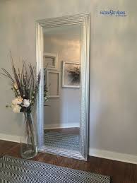 One of the biggest mistakes that people make when decorating tall walls is they get the scale all wrong. Simple Floor Accessory Tall Mirror For An Illusion For Added Space Decorative Clear Vase And Flowers For A Floor Vase Decor Home Decor Vases Tall Floor Vases