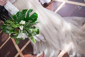 Maybe you would like to learn more about one of these? Wedding Bouquet Of Tropical Flowers Blossom Tropical Flowers And Palm Leaves Monstera Leafs Callas Of White And Green Colors Stock Photo Picture And Royalty Free Image Image 76915910