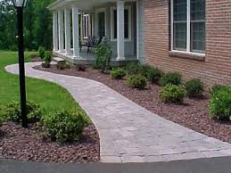 A short retaining wall bridges the divide between path and yard. The Butler Company Hardscape Design Installation Windsor Ct Landscaping Entrance Walkway Landscaping Front Walkway Landscaping