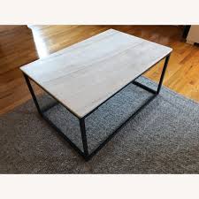 Finished in a rich dark black tapered leg, this wood and marble coffee table coordinates well with most decor styles. World Market Marble Top Coffee Table Aptdeco