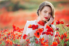 Pretty woman in field of poppy flowers, spring time free download