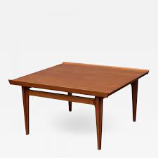 This solid teak coffee table was part of the 500 series that included a square and a rectangular side table with the common feature of a raised lip that runs along the longer side of the tabletop. Finn Juhl Finn Juhl Teak Coffee Table