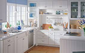 With a pretty cabinet over the sink making a striking statement, the painted kitchen cabinets in the rest of the room offer a pleasing ambiance that guests are sure to gravitate to. Cabinets Kemper Echo Pearl Design Group