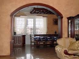A small round dark wood table is situated in between the sofas on which is a clock, plant and lamp. Interior Arches 75 Photos A Spectacular Design Of The Doorway In The Interior Of The Apartment