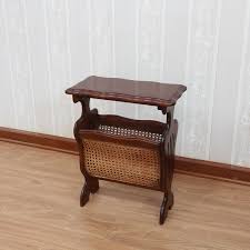 A storage coffee table with drawers or shelves can come in handy. Mahogany And Rattan Magazine Rack
