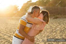 Maybe you would like to learn more about one of these? Excited Adult Man And Woman Kissing And Embracing Each Other On Sandy Shore On Resort Two People Outdoors Stock Photo 309739958