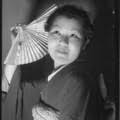 Miss Lil Tokio winner Alice Watanabe poses with a fan in a traditional  kimono in honor of the Nsei festival, Los Angeles, 1935 — Calisphere