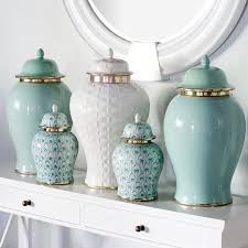 Classic temple jar featuring a detailed design with vibrant gold accents, crafted from ceramic. Pin On Decor Design