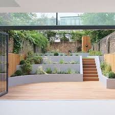 Use Clever Design To Transform An Awkward Space Into An Ideal Outdoor Area Here S Some Advice From Sloped Backyard Sloped Garden Backyard Landscaping Designs