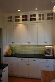 The look comes together with gold hardware fixtures. Glass Doors On Top Lighten The Bank Of Cabinets Without Showing Clutter Traditional Kitchen Glass Cabinet Doors Top Kitchen Cabinets Kitchen Remodel Small
