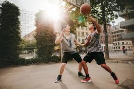 Two Young Men Playing A Game Of Basketball By Jacoblund Teenage Friends Playing Basketball Against Each Other On Basketball Photography Basketball Photos Men
