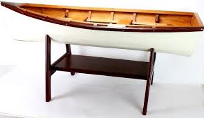 Two palm trees elegantly grow upwards, with each of their slender. Miniature Row Boat Coffee Table On Wood Base