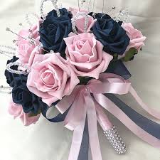 A wedding gown with a lot of bling go well with simple ivory and soft pink flowers, while a simple dress. Brides Posy Bouquet Navy Blue Baby Pink Roses Artificial Wedding Flowers Pink Roses Wedding Pink Wedding Theme Pale Pink Weddings