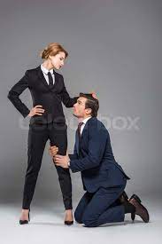 female boss dominating over scared businessman, isolated on grey, feminism  concept | Stock image | Colourbox