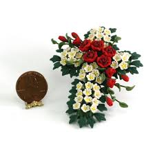The cross is carried at the head of the procession, and banners embroidered with sacred pictures in places where this is customary; Cross Shaped Flower Arrangement Or Grave Blanket Dollhouses And More